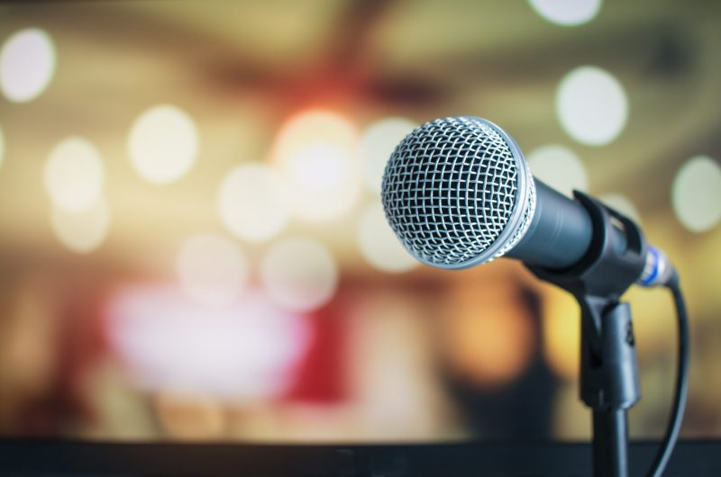 Microphone,On,Abstract,Blurred,Of,Speech,In,Seminar,Room,Or Microphone,On,Abstract,Blurred,Of,Speech,In,Seminar,Room,Or
